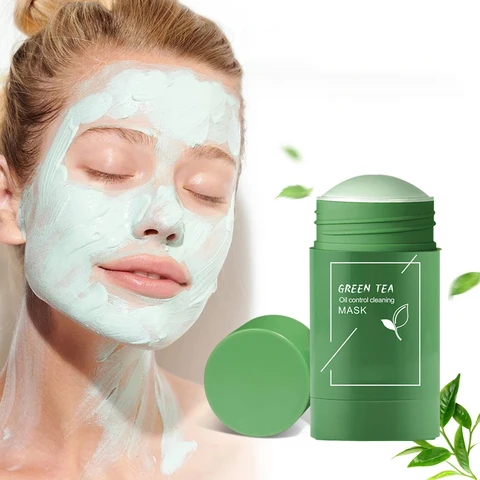 Woman with green tea face mask applied